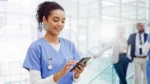 Healthcare professional in a hospital looking at mobile phone